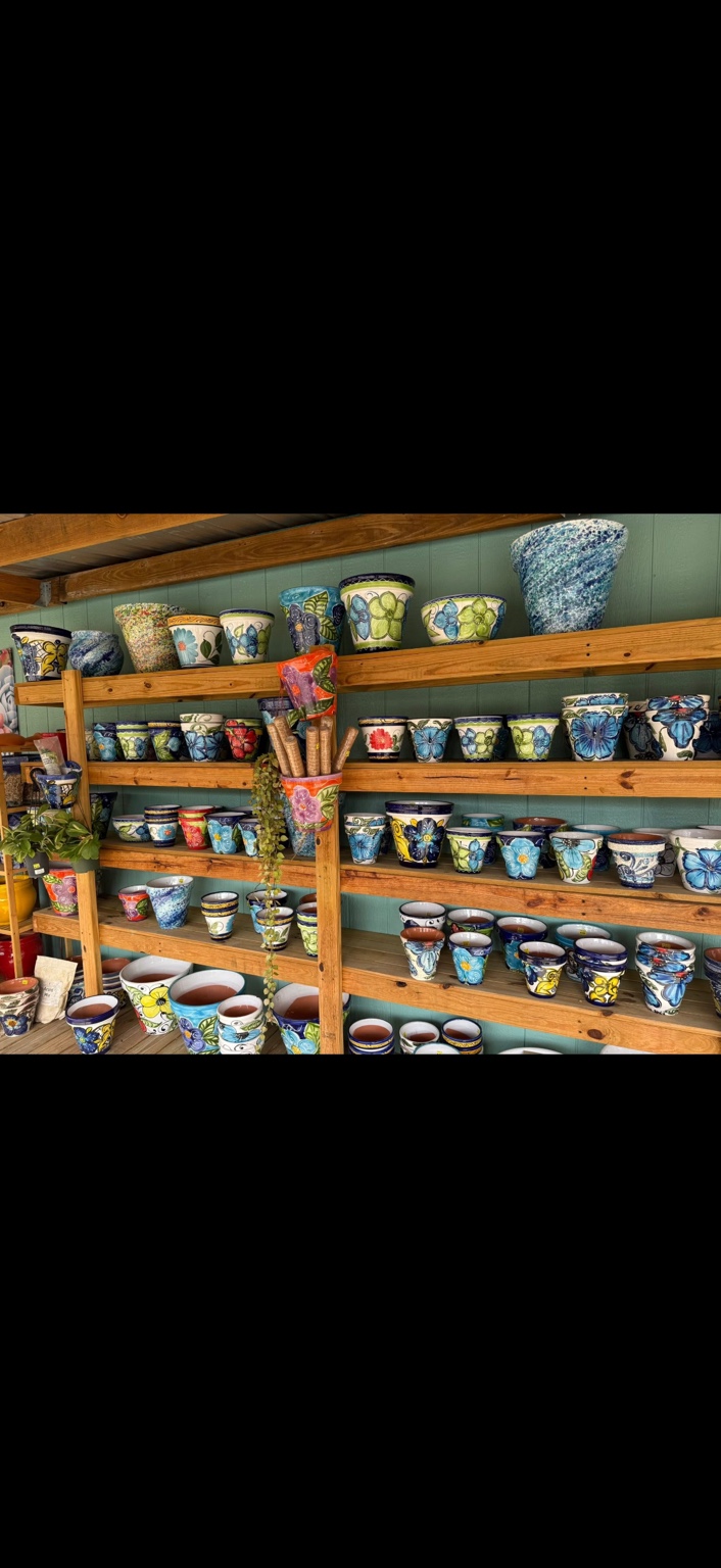 Shelves of colorful patterned pots at the farm